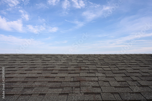 Dark roof tiles with blue sky photo