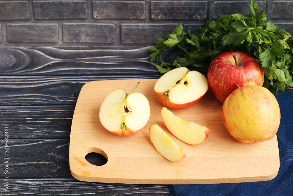 Slicing apples on a light wooden board, a dark wooden background Slicing apples on a light wooden board, a dark wooden background