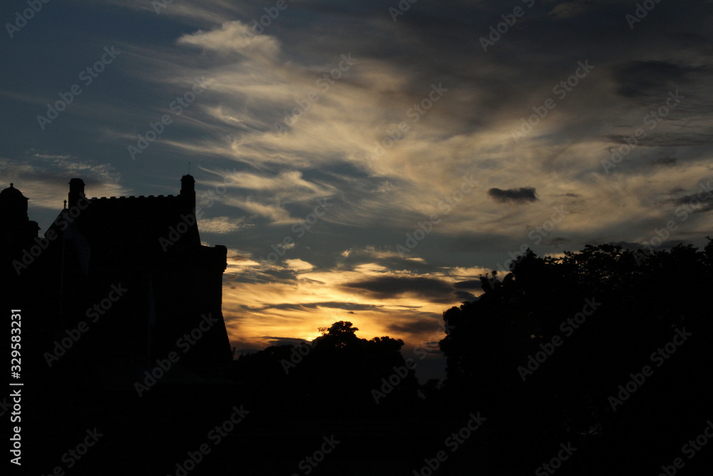  clouds at dusk with the silhouette of a fortified castle