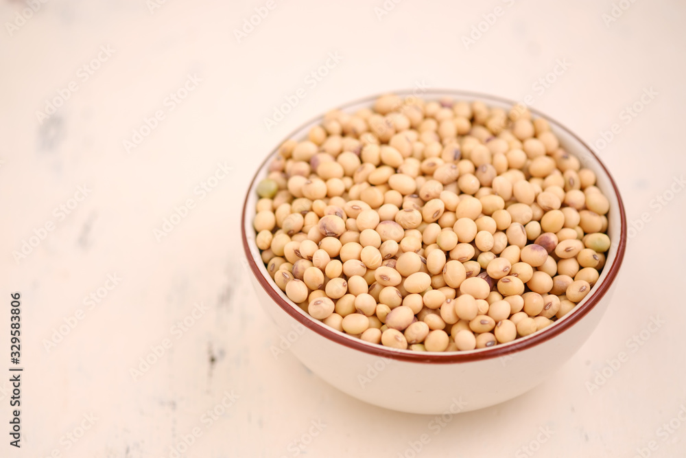 Soy bean in bowl on floor and copy space.soybeans dry on white backdrop.