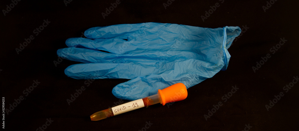close up healthcare medical mask with blue glove and medical blood collection tube for coronavirus covid 19 on black background