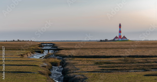 panoramic view of the beautiful and most famous Lighthouse Westerheversand at Westerhever in Nordfriesland in the German state of Schleswig-Holstein photo