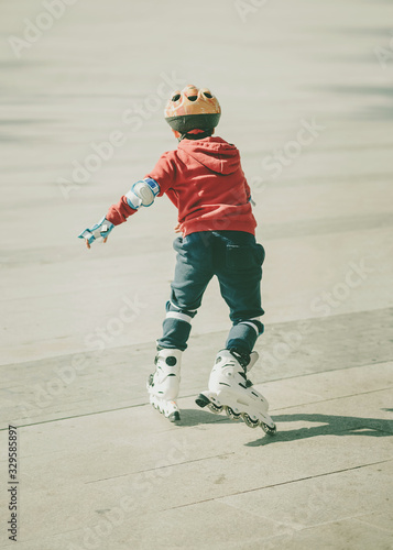 child skating with helmet on the street