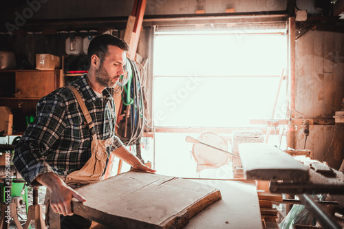 Carpenter working on woodworking in carpentry workshop