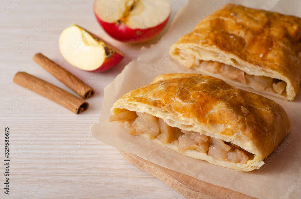 Apple strudel on a  wooden board. Homemade pastries. 