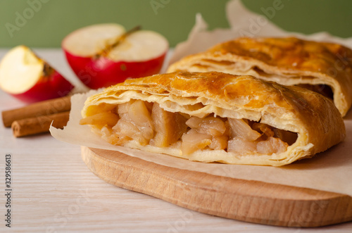 Apple strudel on a  wooden board. Homemade pastries. 