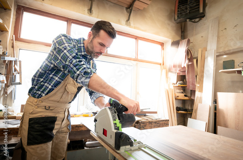 Carpenter working on woodworking in carpentry workshop