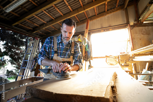 Carpenter working on woodworking in carpentry workshop © leszekglasner