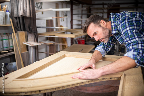 Carpenter working on woodworking in carpentry workshop