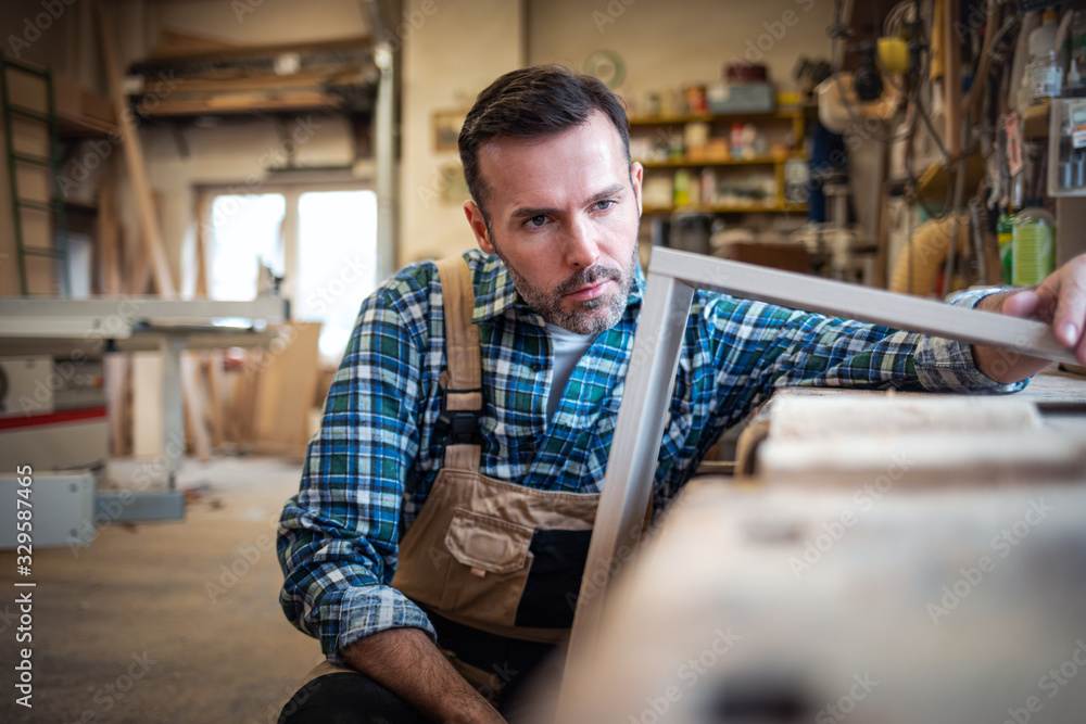 Carpenter working on woodworking in carpentry workshop