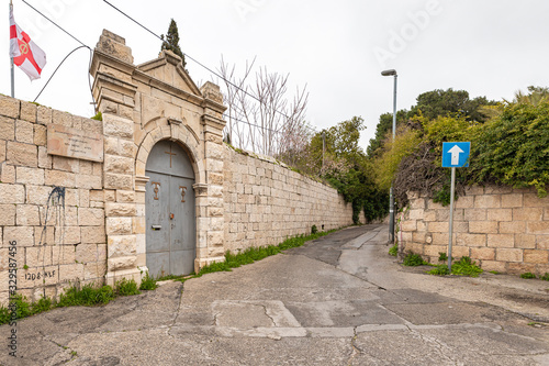 The closed gate of the abandoned Greek Orthodox Church on Aminadav St  in the old district of Jerusalem city in Israel photo