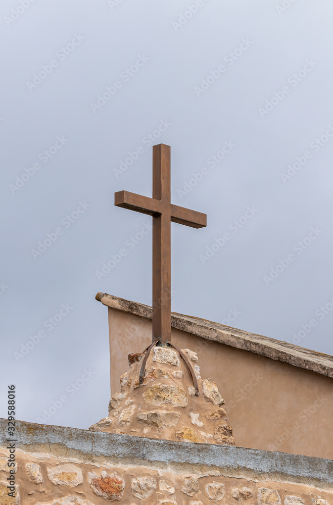 The large metal cross on the roof of the abandoned Greek Orthodox Church at the end of the street in the old district of Jerusalem city in Israel