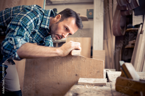 Carpenter working on woodworking in carpentry workshop