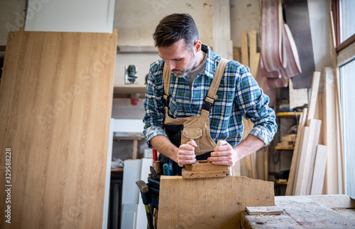 Carpenter working on woodworking in carpentry workshop