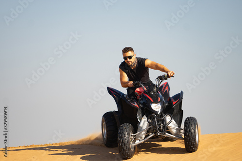 Muscular Man Riding Atv In the Desert