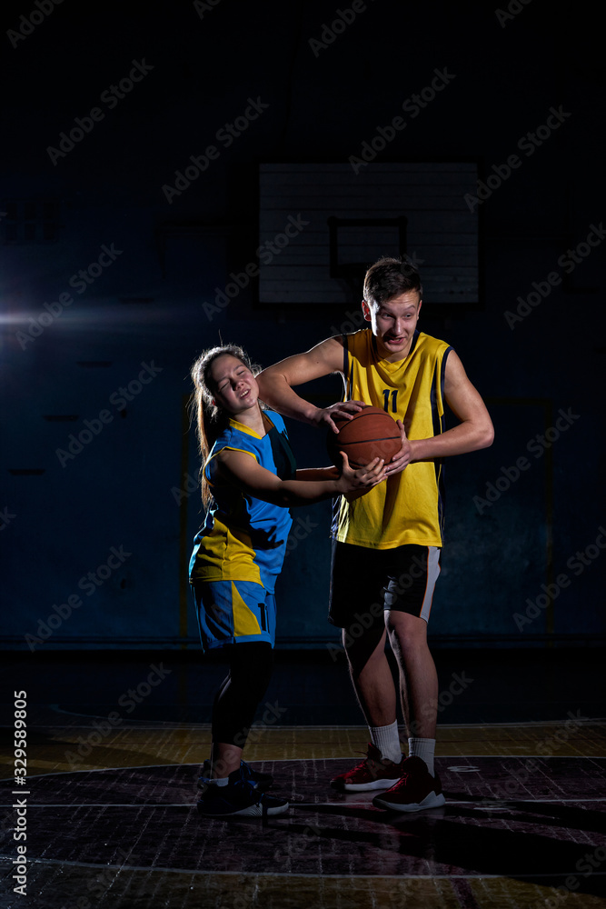 The boy hit the girl with his elbow while playing basketball. The boy hit the girl with his elbow while playing basketball.