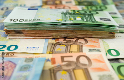 stack of euro banknotes on a euro background. Money background. Business concept. A lot of money for the background.