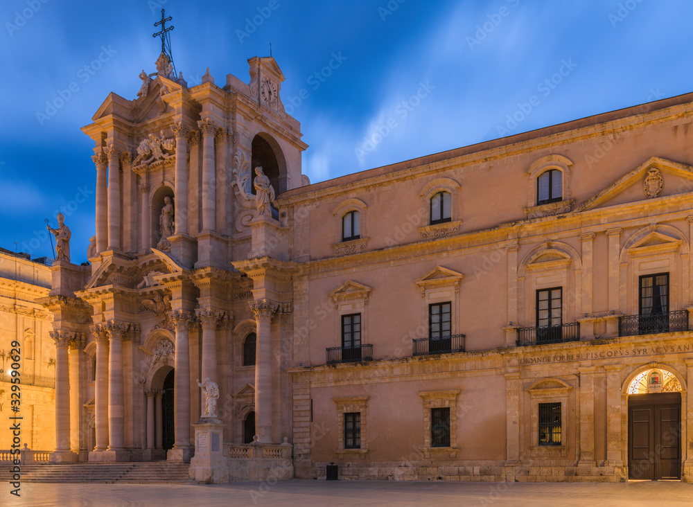 Ancient catholic church, the Cathedral of Syracuse (Duomo di Siracusa)  in the historic square in the city center of Ortygia island in Sicily at sunrise with amazing blue sky 