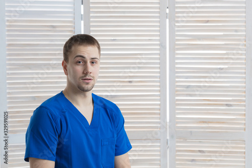 Portrait of a young male doctor in a medical office