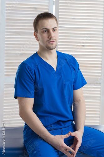 Portrait of a young male doctor in a medical office