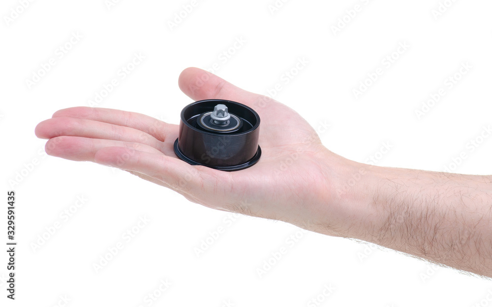 Hand holding new auto engine rollers on white background isolation Hand holding new auto engine rollers on white background isolation