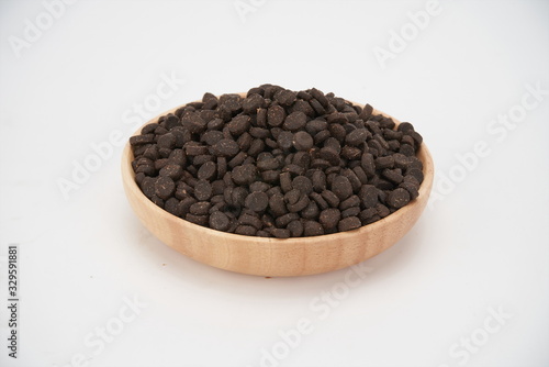 Dog food in wooden bowls on a white background