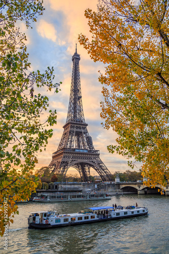  Peniche passing in front of the Eiffel tower in Paris France on an autumn day surrounded by brown leaves of trees, tour Eiffel in the fall