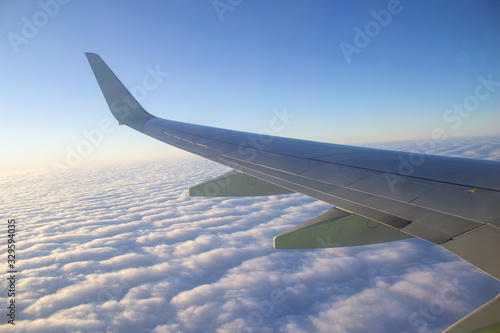 Airplane wing in the sky. View from a great height.