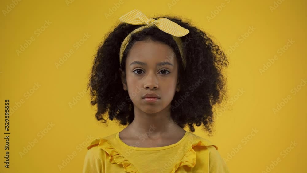 cute african american kid looking at camera isolated on yellow cute african american kid looking at camera isolated on yellow
