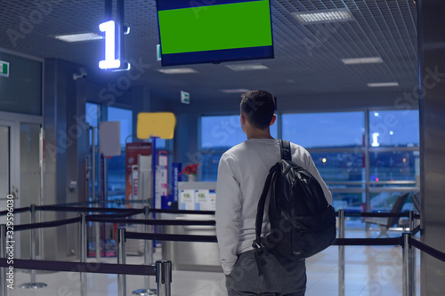 A man at the airport, one is landing, VIP registration. The man was late to the airport. How much do you need to go to the airport. A man with a backpack at the airport. green tv