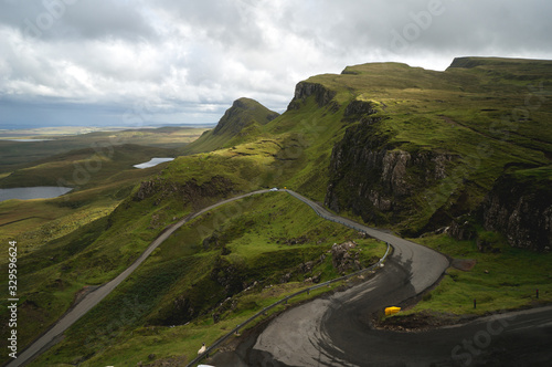 Long winding road at Quiraing on the Isle of Skye with a beautiful vibrant scottish sky.