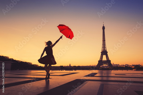 tourist travel to Paris, silhouette of happy woman with red umbrella near Eiffel Tower