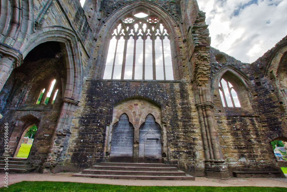 Fototapeta premium The ruins of Tintern Abbey, founded by Walter de Clare, Lord of Chepstow, on 9 May 1131. It is situated adjacent to the village of Tintern in Monmouthshire, Wales, UK.