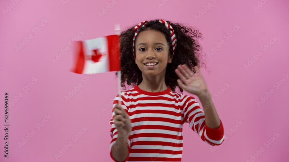 african american child with canadian flag isolated on pink african american child with canadian flag isolated on pink