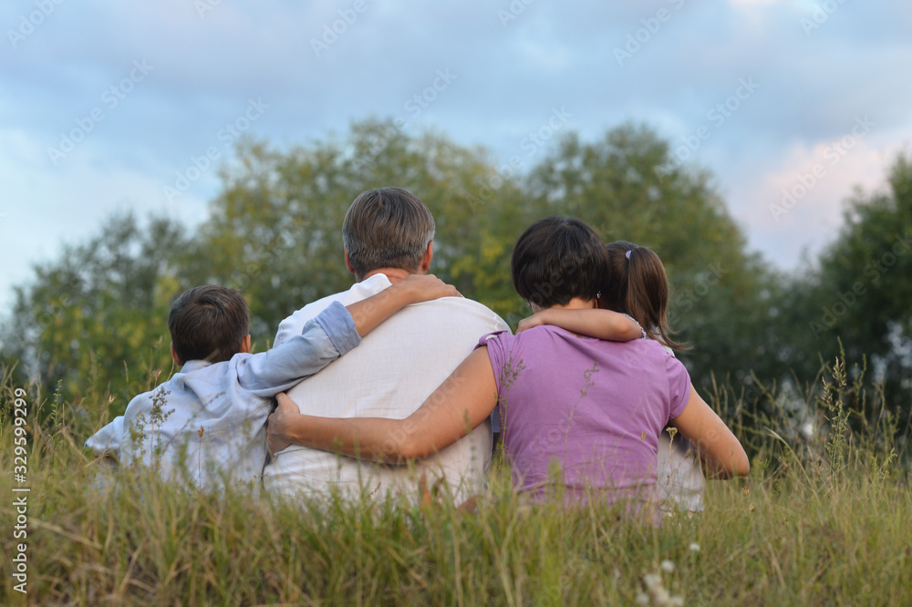 Happy parents and children at summer field Happy parents and children at summer field