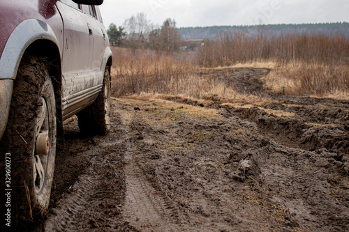 Off-road vehicle on a dirt track, off-road 4x4 in bad weather, visible dirt on wheels