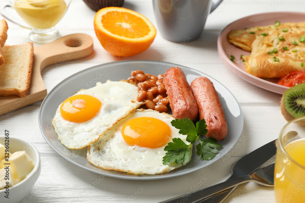 Delicious breakfast or lunch with fried eggs on wooden background, close up Delicious breakfast or lunch with fried eggs on wooden background, close up