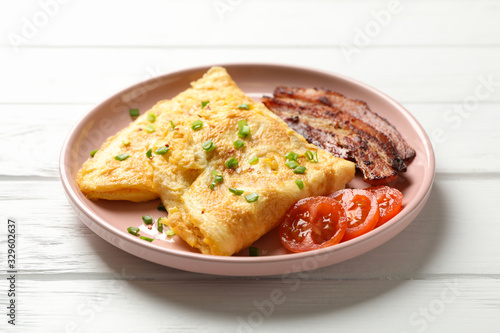 Delicious breakfast or lunch with omelette on wooden background, close up