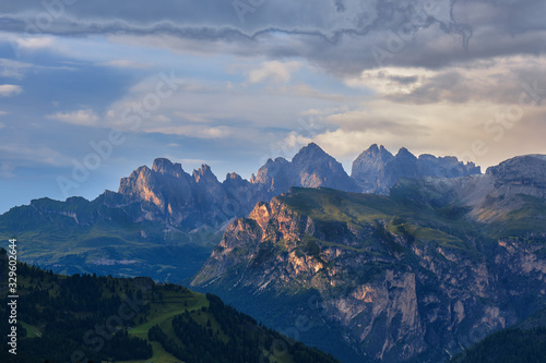 Surreal sky after storm in Dolomites mountains, Italy, with the last rays of light touching the mountain peaks.