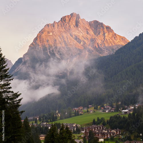 Colac mountain above Alba village, at sunset, in Dolomites mountains, Italy.