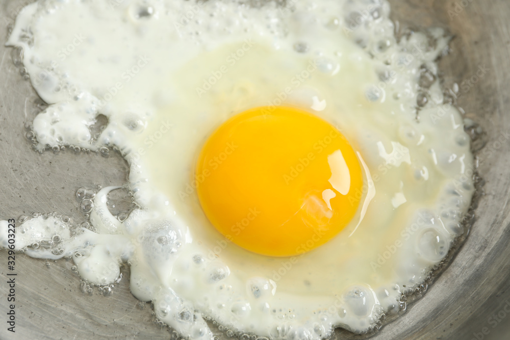 Delicious fried egg on pan, close up Delicious fried egg on pan, close up