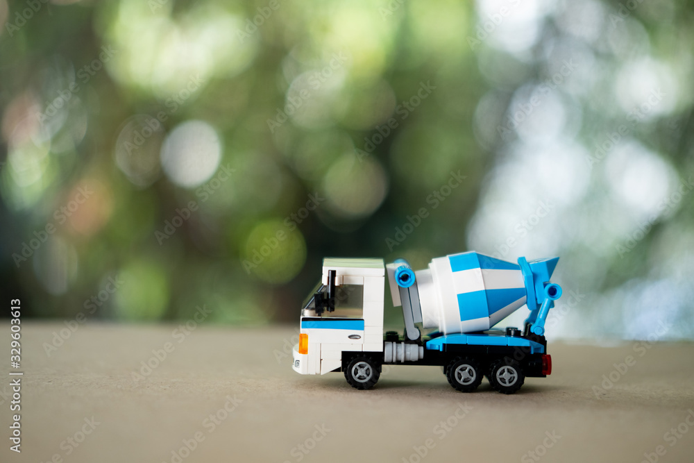 Blue cement mixer truck toy. Business commercial concept.