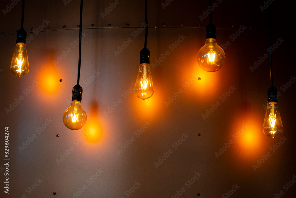 Decorative lamps with apparent filament. Metal background with exposed screws. Decorative lamps with apparent filament. Metal background with exposed screws.