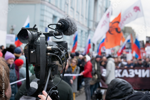 Videographer is reporting from a city street during a mass political action in Moscow, Russia. Camera is up of the crowd photo