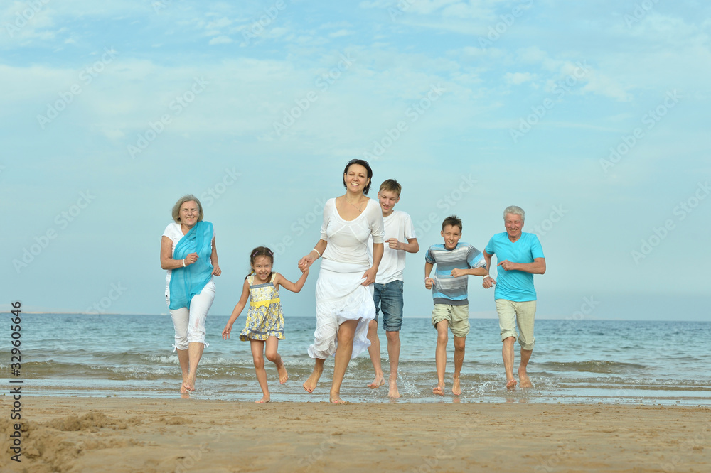 Portrait of happy family together on sand beach