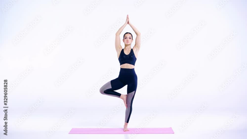 sportive girl practicing on pink fitness mat on white sportive girl practicing on pink fitness mat on white