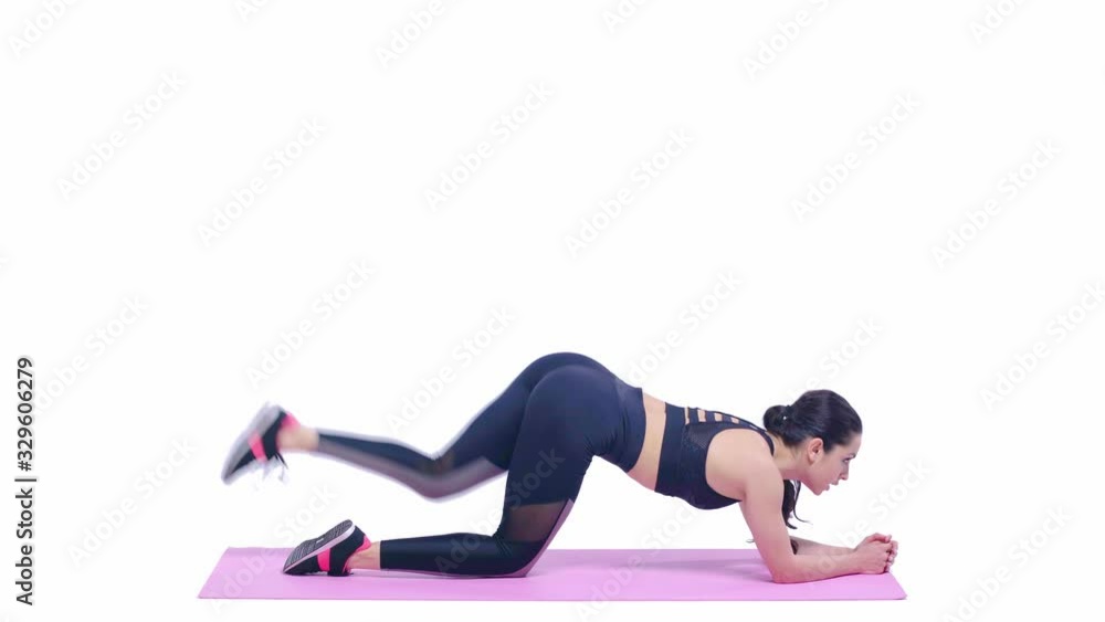 side view of sportswoman exercising on fitness mat isolated on white side view of sportswoman exercising on fitness mat isolated on white