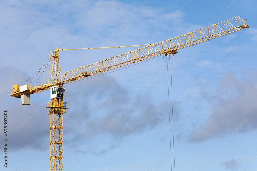 Big hoisting crane standing at blue sky Big hoisting crane standing at blue sky