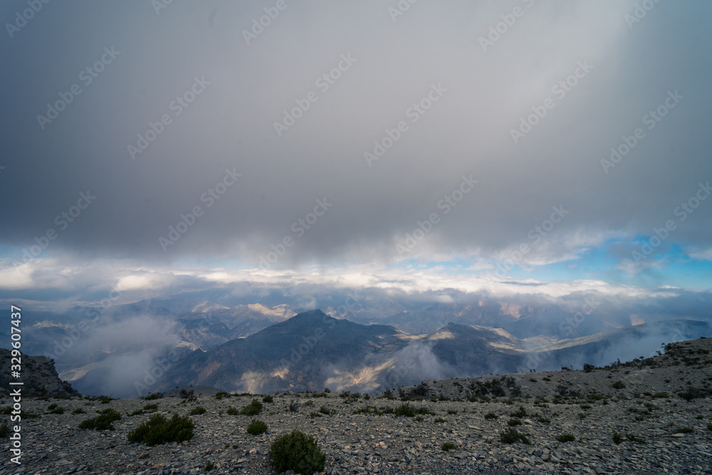 Panoramic of a hillside on a cloudy day in Jabal Shams, Oman