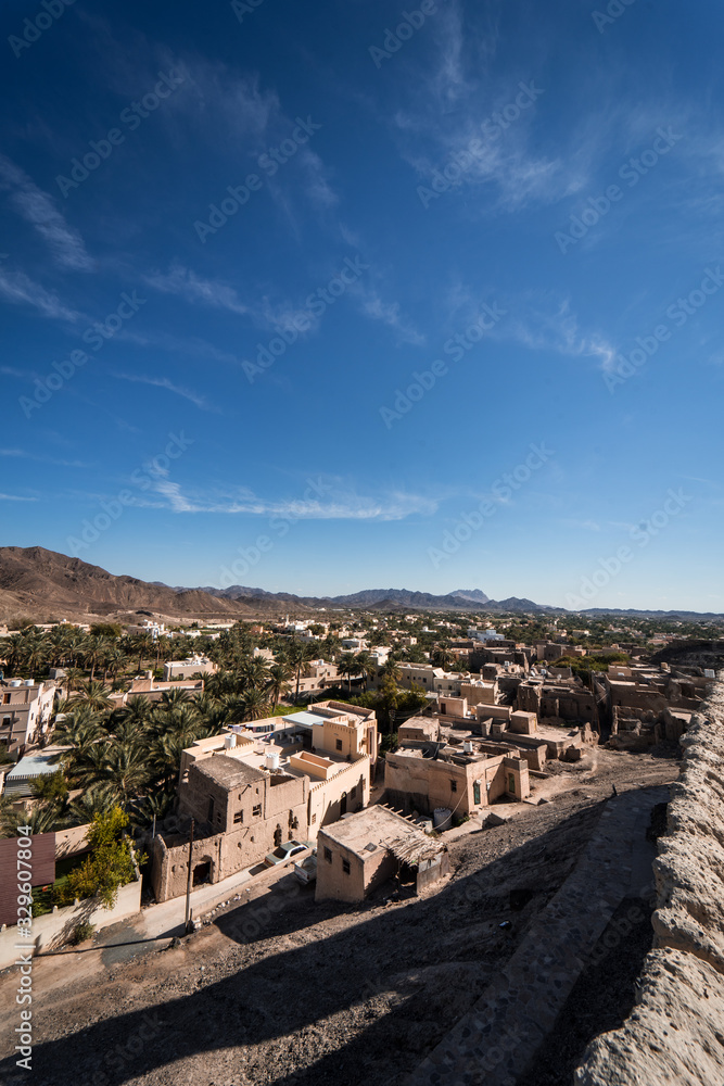 Aerial view of the city with the mountains in the background from the Bahla Fort, Oman